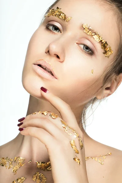 Woman with golden foil on face and body — Stock Photo, Image