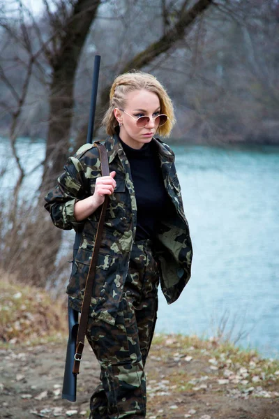 Kaukasische Frau Tarnanzug Und Sonnenbrille Mit Schrotflinte Auf Der Schulter Stockbild