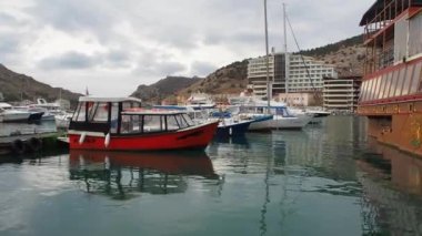 Sevastopol, Balaklava Bay, Crimea, Russia-March 26, 2021:Boats and Yachts near the pier in the bay of Balaclava, Crimea