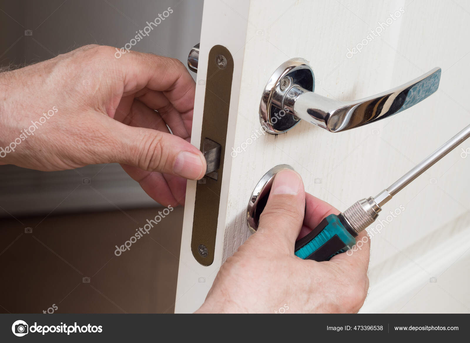 Worker Installing Repairing New Lock Door Knob Screwdriver