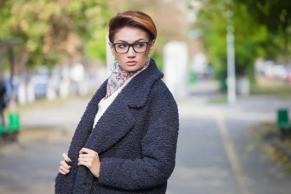 Mooie jonge vrouw met glazen wandelen in de stad, lente foto 's — Stockfoto