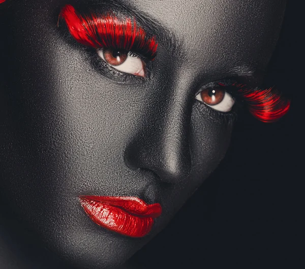 Creative and fashion portrait of a dark-skinned girl with color make-up — Stock Photo, Image