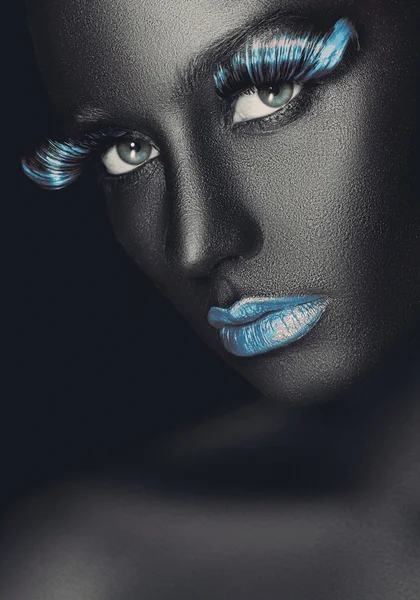 Creative and fashion portrait of a dark-skinned girl with color make-up — Stock Photo, Image