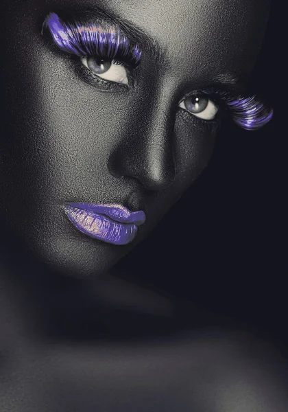 Creative and fashion portrait of a dark-skinned girl with color make-up — Stock Photo, Image