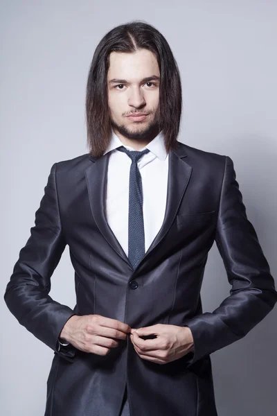 Stylish man with long hair in elegant blue suit — Stock Photo, Image