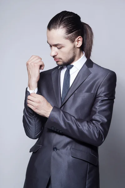 Stylish man with long hair in elegant blue suit — Stock Photo, Image