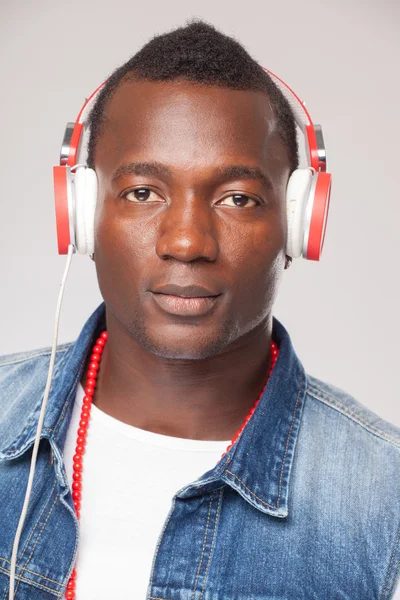 Handsome African man listening to music on DJ headphones — Stock Photo, Image