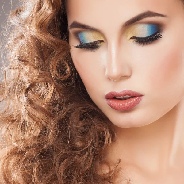Portrait of an young girl with beautiful make-up and curly hair Stock Photo