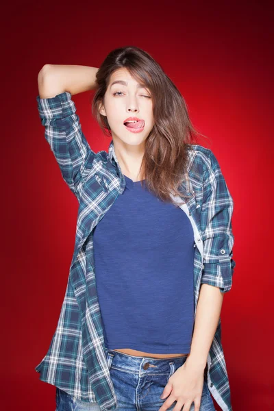 Young beautiful girl posing grimacing with chewing gum — Stock Photo, Image