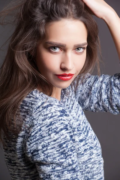 Fashion portrait of beautiful woman with red lips in knitted sweater — Stock Photo, Image