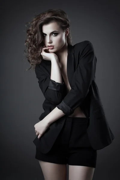 Fashion shoot of young woman in black jacket and shorts — Stock Photo, Image