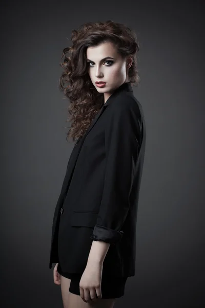 Fashion shoot of young woman in black jacket and shorts — Stock Photo, Image