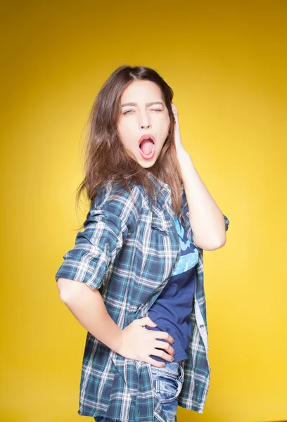 Young beautiful girl posing grimacing with chewing gum — Stock Photo, Image