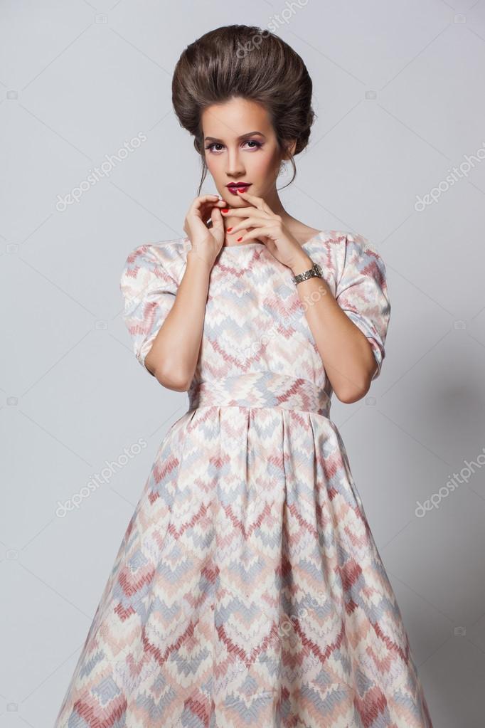 Beautiful Girl In Short Pink Dress And Trendy Hairstyle Stock Photo,  Picture and Royalty Free Image. Image 121781693.