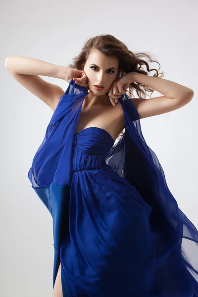 Sexy woman in fluttering blue dress Royalty Free Stock Photos