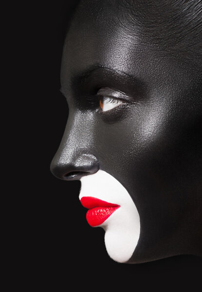 Close-up fashion portrait of a dark-skinned girl with red lips