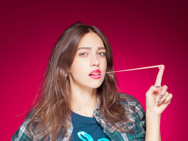 Young beautiful girl posing grimacing with chewing gum