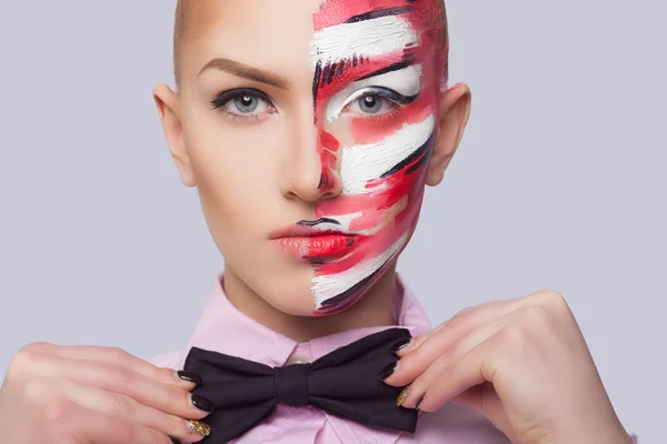 Beautiful fashion woman with bright color face art and body art. Paint on face. Creative portrait