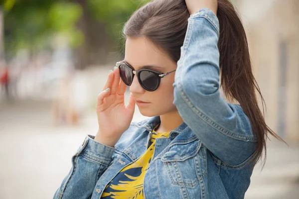 Retrato de moda mujer bonita con estilo en gafas de sol posando en la ciudad —  Fotos de Stock