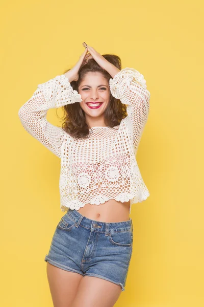 Young happy beautiful girl posing grimacing in studio — Stock Photo, Image