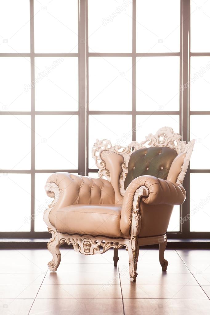 beautiful Baroque armchair near a big window