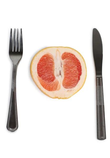 Grapefruit with fork and knife — Stock Photo, Image