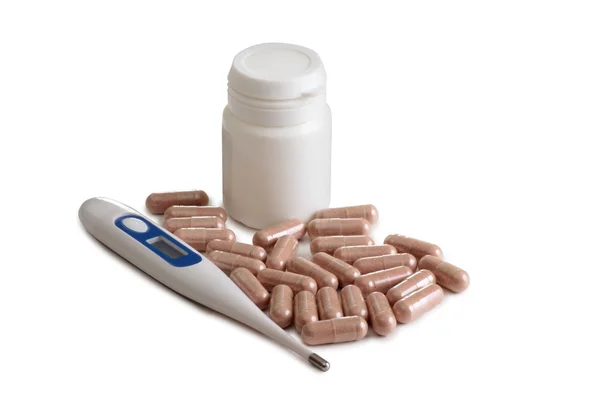 Pills and thermometer on white — Stock Photo, Image