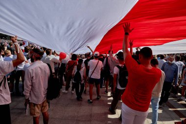 August 16 2020 Minsk Belarus Many people walk during a demonstration under a large opposition flag of Belarus