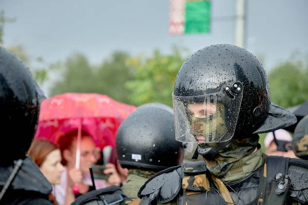 Young Armed Police Officer Watches Protesters Pouring Rain — Stock Photo, Image