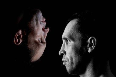 Bir kişinin portresi iki taraflı psikolojik fotoğrafçılık. Adam ters yansımasına bakıyor.