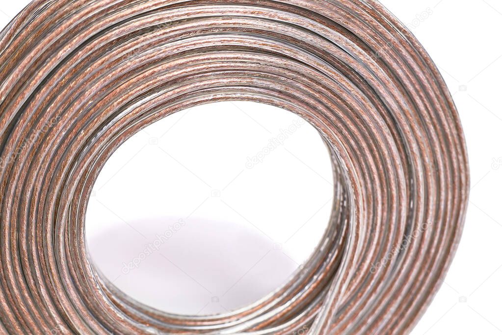 A coil of braided copper cable, insulated with white