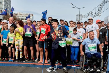 15 Eylül 2019 Minsk Belarus tekerlekli sandalyedeki atletlerin yanında madalyalı bir gazi duruyor.