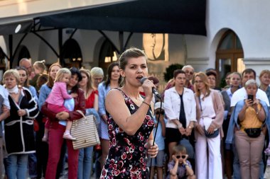 May 25, 2019 Minsk Belarus A beautiful woman with a microphone sings in front of a crowd of people