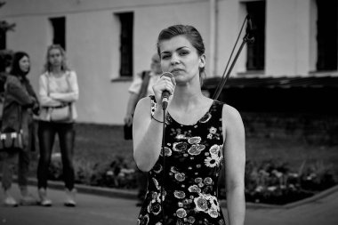 May 25, 2019 Minsk Belarus A street concert in which a young woman with a microphone sings.Black and white image