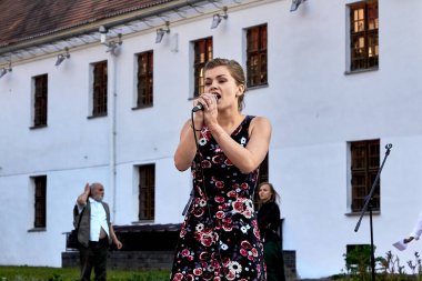 May 25, 2019 Minsk Belarus Street concert in which a beautiful Caucasian woman sings in the evening on the street