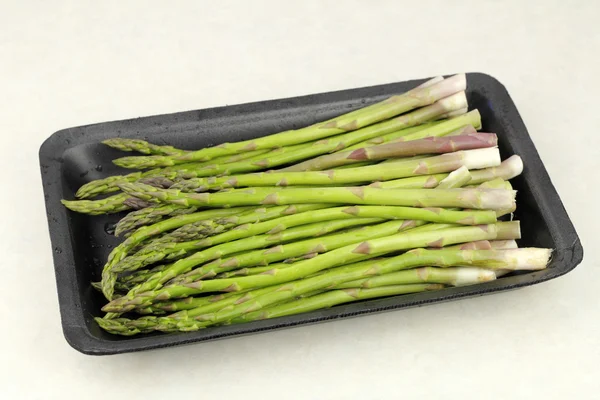 Raw Asparagus in a Plastic Tray — Stock Photo, Image