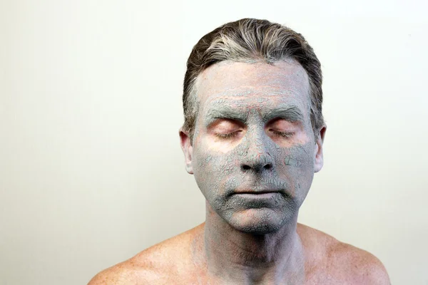 Man Wearing a Clay Mask