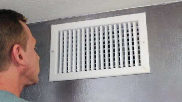 Man Looking in an Air Vent — Stock Footage Man Looking in an Air Vent Royalty Free Stock Video