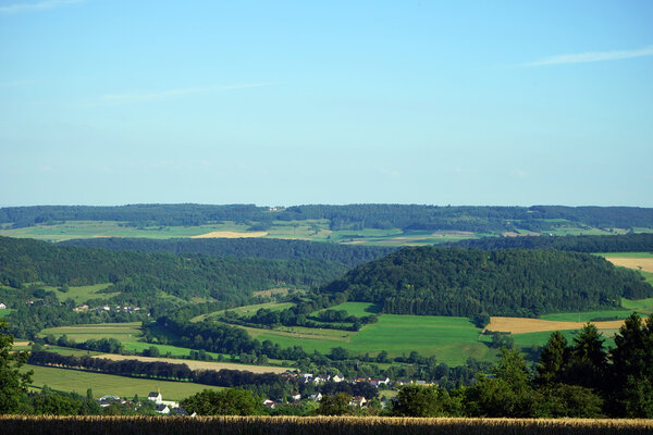 View of farm field and green hills in Luxembourg