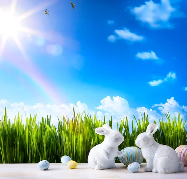 Art Little Easter bunny and Easter eggs on green grass — Stock Photo, Image