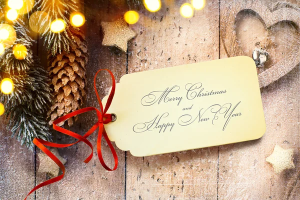 Fond de Noël avec lumière d'arbre et carte de papier de Noël — Photo