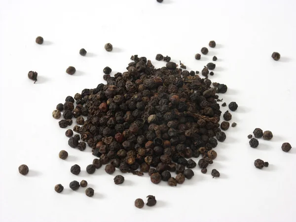 Black pepper on the white background — Stock Photo, Image