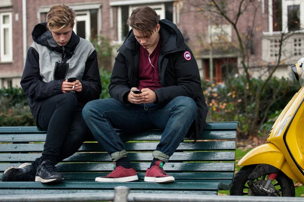 Adolescentes con teléfonos celulares — Foto de Stock