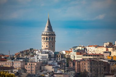 İstanbul, Türkiye - 4 Ekim 2025: Güneşli bir sonbahar öğleden sonrasında, Ortaçağ 'a ait tarihi bir taş yapı olan Galata Kulesi, Beyoğlu' nun çatılarından yükseliyor..
