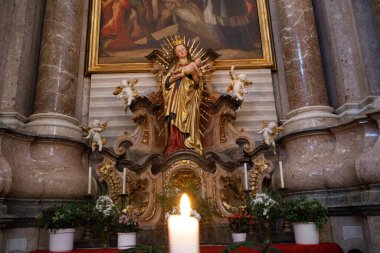 Fussen, Almanya - 19 Eylül 2023: Aziz Mang Bazilikası 'nın içindeki Barok sunağında, meleklerle çevrili bebek İsa' yı tutan Bakire Meryem 'in altın heykeli.