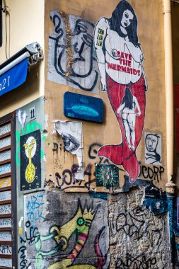 Naples, Italy - November 4, 2022: Modern street art featuring a mermaid with the text 