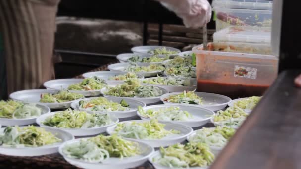 Street food - salad served on disposable plates — Stock Video