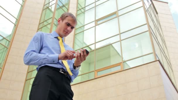 Sad businessman looking on cellphone — Stock Video