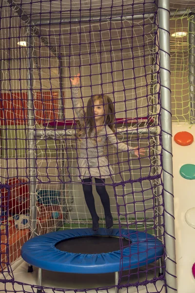 Little girl on the trampoline — Stock Photo, Image