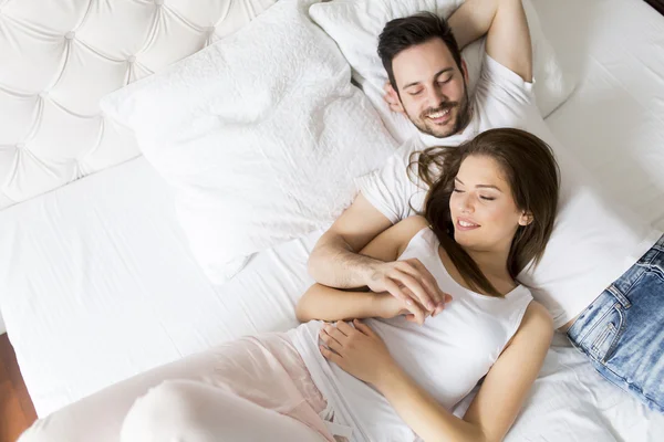 Young couple in the bed — Stock Photo, Image